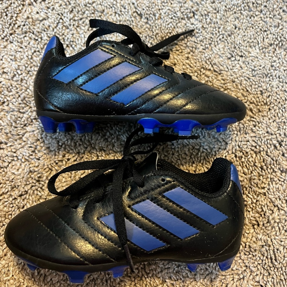 Black with blue US 10k Adidas kids soccer cleats.